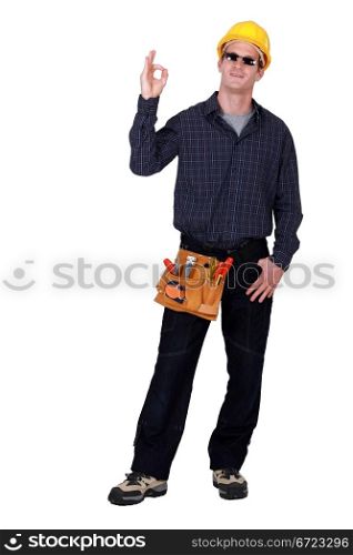 workman with sunglasses making okay sign