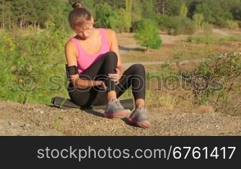 Workout fitness injuries young woman with pain in the leg muscles during exercise outdoors
