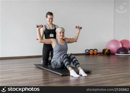 workout with personal trainer arm exercise with dumbbells