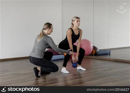 workout with personal trainer doing squats