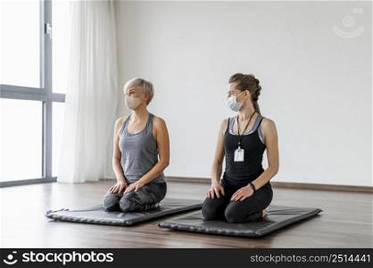workout with personal trainer sitting their knees