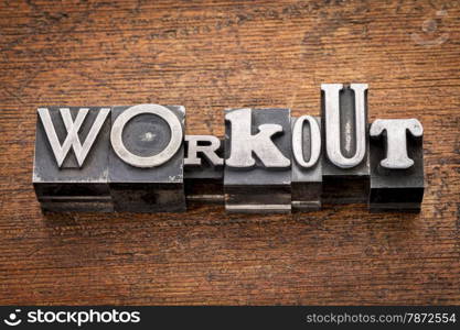 workout word in mixed vintage metal type printing blocks over grunge wood