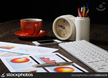 Workplace at office. Workplace with keyboard cup of coffee and graphs