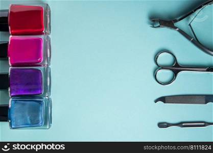 Workplace in a nail salon. A set of tools for hand care on a blue background. Place for text.. Workplace in a nail salon. A set of tools for hand care on blue background. Place for text.