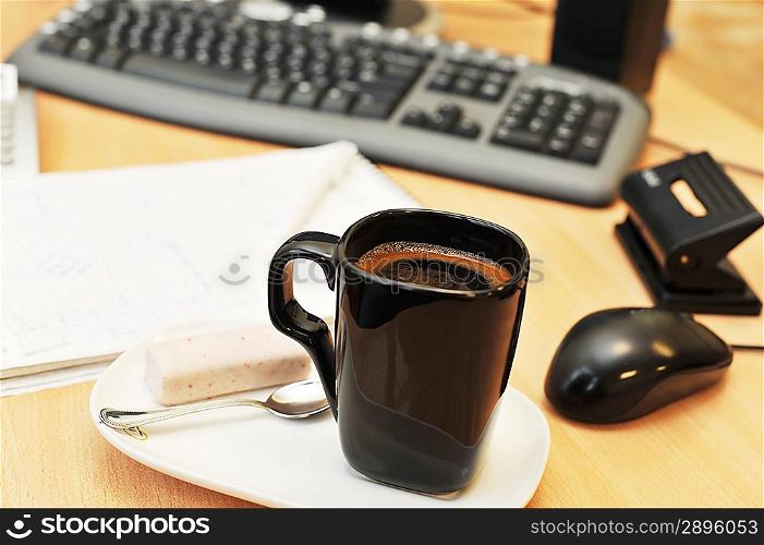 Workplace in office with monitor and cup on work table