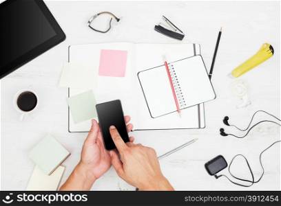 Workplace. Top view. Man working with modern devices and writing on notebook