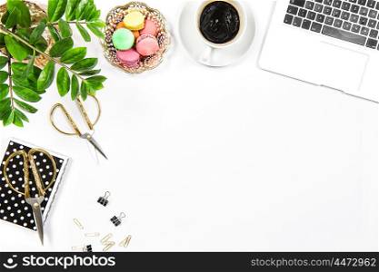 Workplace with coffee, cookies, laptop computer and green plant on white table background. Top view. Flat lay