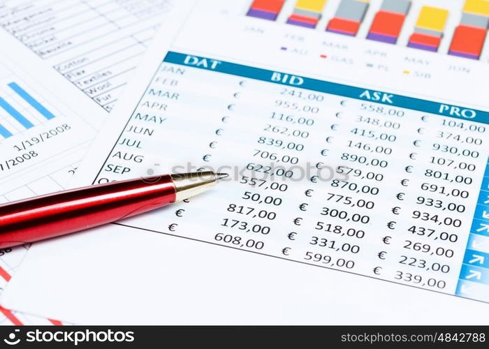 Workplace with documents. Close up of papers with graphs and diagrams