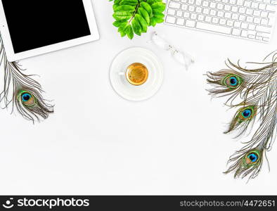 Workplace with keyboard, tablet pc, coffee, green plant. Office desk white background