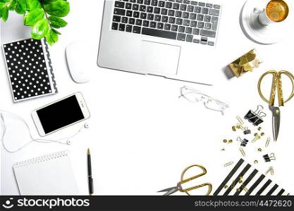 Workplace with notebook, digital phone, office supplies, diary, coffee, green plant. Creative working desk