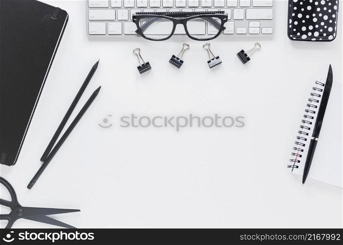workplace with stationery glasses keyboard