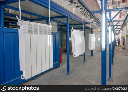 workshop for assembling and painting household heating radiators. conveyor line painting and drying of household heating radiators. assembly and painting heating radiators in manufacturing