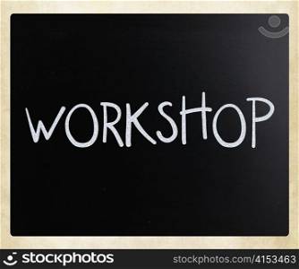 ""Workshop" handwritten with white chalk on a blackboard"