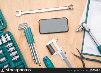 Workshop table with many tools. Wrench, spanner, calliper and ratchet with many attachments. Work tools. Universal tool set. Professional equipment. Background