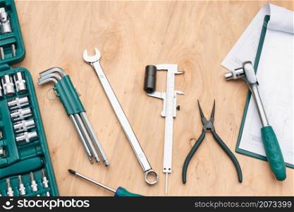 Workshop table with many tools. Wrench, spanner, calliper and ratchet with many attachments. Work tools. Universal tool set. Professional equipment. Background