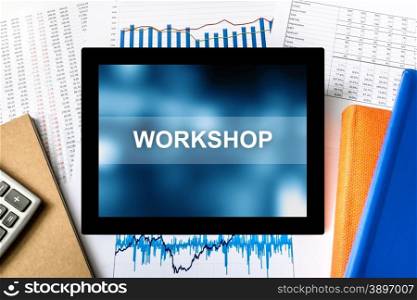 workshop word on tablet with financial graph background