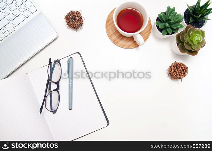 Workspace with laptop, notebook, sketchbook, succulent, cup of tea on white background. Flat lay, top view office table desk. Freelancer working place. copyspace.. Workspace with laptop, notebook, sketchbook, succulent, cup of tea on white background. Flat lay, top view office table desk. Freelancer working place. copyspace