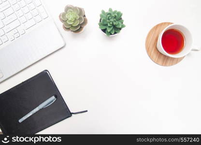 Workspace with laptop, notebook, sketchbook, succulent, cup of tea on white background. Flat lay, top view office table desk. Freelancer working place. copyspace.. Workspace with laptop, notebook, sketchbook, succulent, cup of tea on white background. Flat lay, top view office table desk. Freelancer working place. copyspace