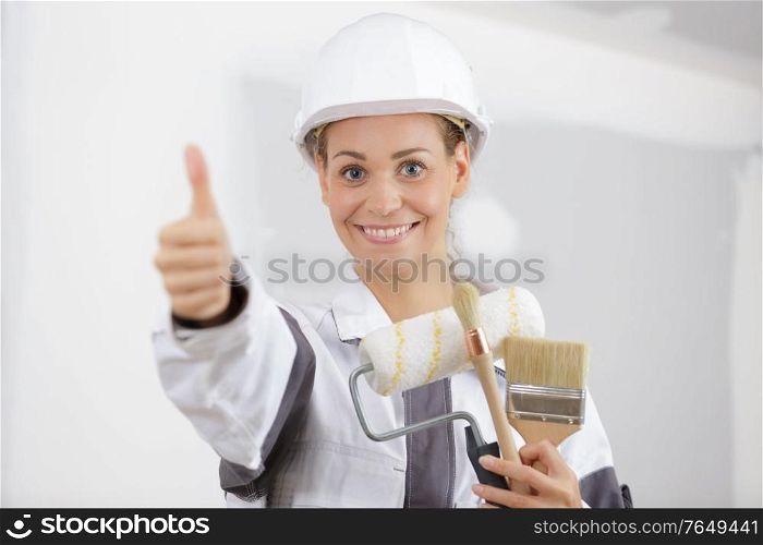 workwoman gives thumbs up in front