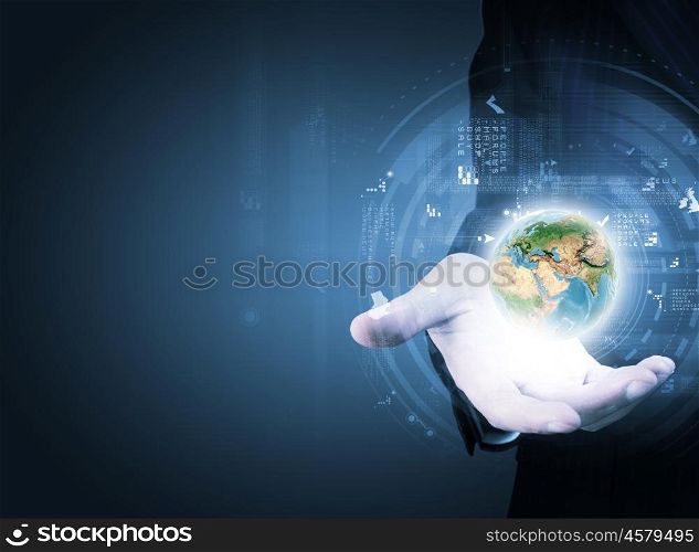World and global technologies. Close up of businessman holding Earth planet in palm. Elements of this image are furnished by NASA