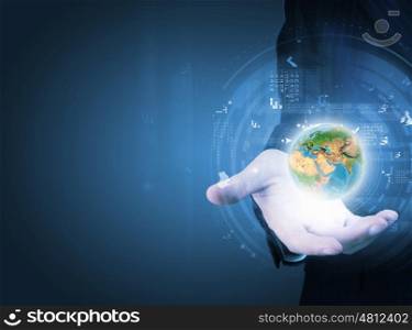 World and global technologies. Close up of businessman holding Earth planet in palm. Elements of this image are furnished by NASA