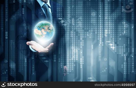 World and global technologies. Close up of businessman holding Earth planet in palm. Elements of this image are furnished by NASA