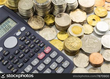 world currency coins and calculator, concept for banking and saving