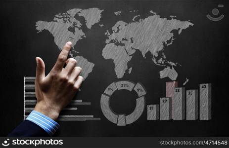 World economy. Global economics concept with male hand touching world map