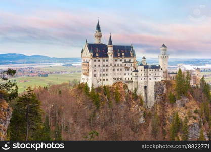 World-famous tourist attraction in the Bavarian Alps, fairytale Neuschwanstein or New Swanstone Castle, the 19th century Romanesque Revival palace at sunset, Hohenschwangau, Bavaria, Germany. Fairytale Neuschwanstein Castle, Bavaria, Germany