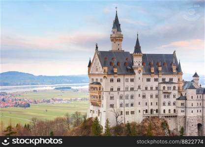 World-famous tourist attraction in the Bavarian Alps, fairytale Neuschwanstein or New Swanstone Castle, the 19th century Romanesque Revival palace at sunset, Hohenschwangau, Bavaria, Germany. Fairytale Neuschwanstein Castle, Bavaria, Germany