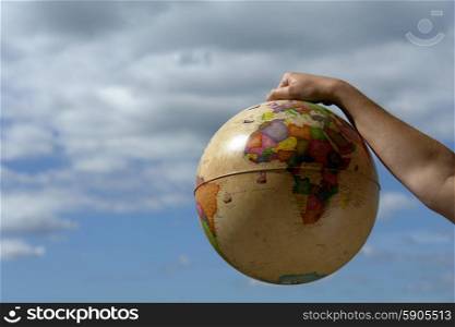 world globe in woman hand and the sky