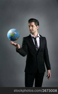 World globe map sphere in businessman hand over dark gray background