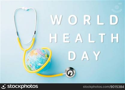 World Health Day. Top view yellow doctor stethoscope wrapped around world globe isolated on pastel blue background with copy space for text, Global healthcare, Health care and medical concept