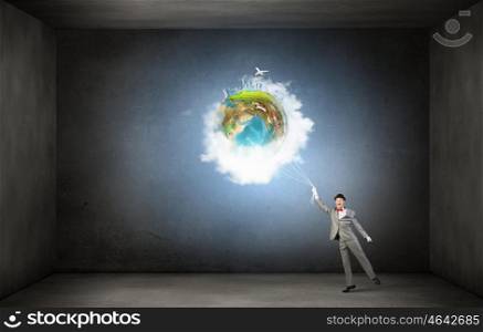 World in his hands. Businessman catch Earth planet with rope . Elements of this image are furnished by NASA