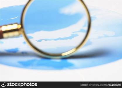 World map and Magnifying glass