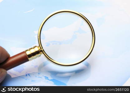 World map and Magnifying glass