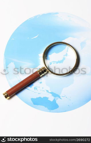 World map and Magnifying glass