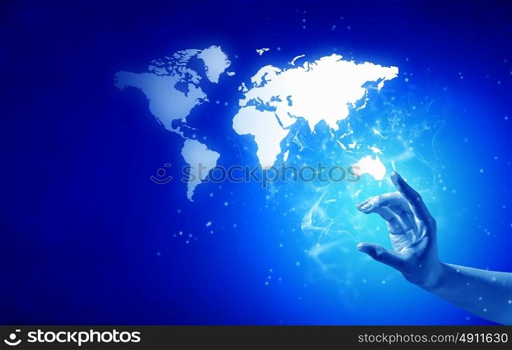 World map. Person hand taking world map on blue background