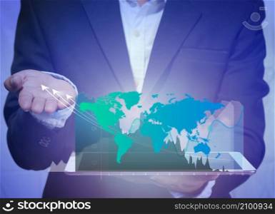 world market trading concept with digital tablet in the human hand and digital finance chart and world map on dark background with copy space. virtual world online marketing concept Metaverse.
