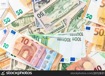 World money concept, detail on EURO and US dollar banknotes, EURO and US currency background, inflation, finance and business concept