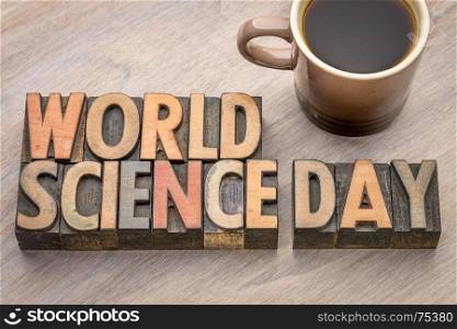 World Science Day - word abstract in vintage letterpress wood type with a cup of coffee