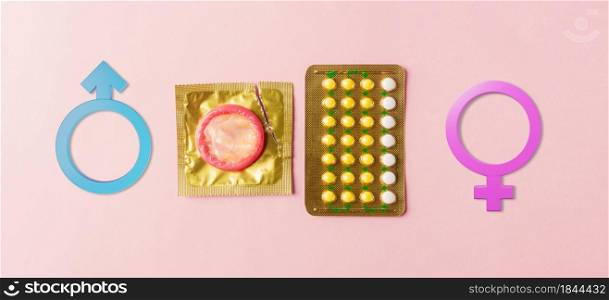 World sexual health or Aids day, condom on wrapper pack, contraceptive pills blister hormonal birth control pills and Male, female gender signs on a pink background, Safe sex and reproductive health