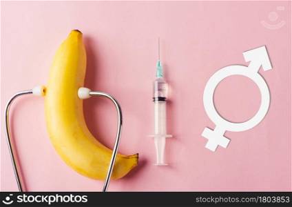 World sexual health or Aids day, Top view flat lay condom in wrapper pack, syringe, Male, female gender signs and doctor stethoscope on a pink background, Safe sex and reproductive health concept