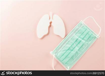World TB Day. Overhead lungs paper symbol and facial medical face mask on pastel pink background, lung cancer awareness, copy space concept of world tuberculosis day, banner background