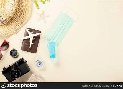 World Tourism Day during coronavirus outbreak, Top view model plane and medicine face mask, holiday accessory beach trip travel vacation, studio shot isolated pastel background with copy space