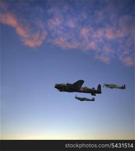 World War 2 RAF airplanes floying over lovely sunset golden hour