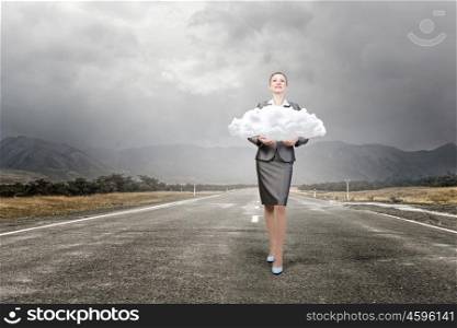 Worldwide data sharing. Attractive businesswoman holding cloud as computing concept