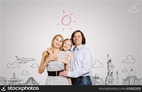 Worldwide traveling. Happy family of three and sketches at background