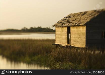 Worn out building in marsh at sunset on Bald Head Island, North Carolina.