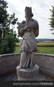 WORNITZSTEIN, GERMANY - 1 SEPTEMBER 2015 Statue of saint with cross near bridge